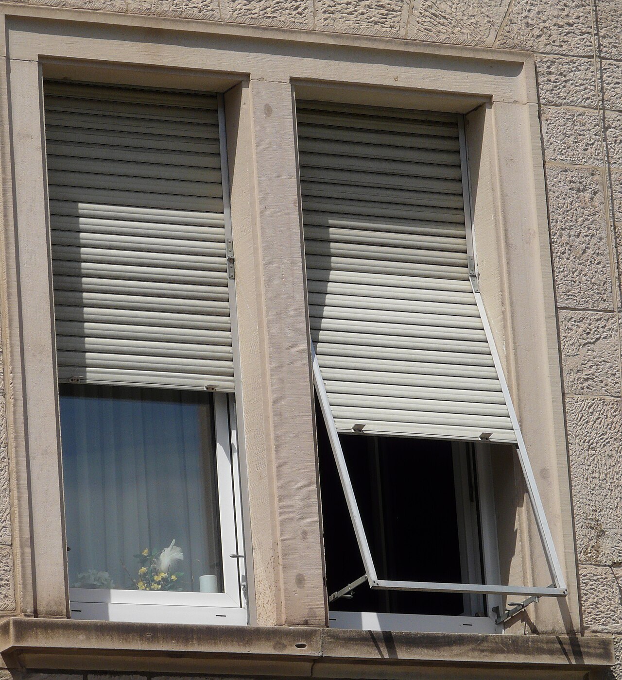 Close-up of a residential roller shutter: slats and track to check when the shutter is jammed
